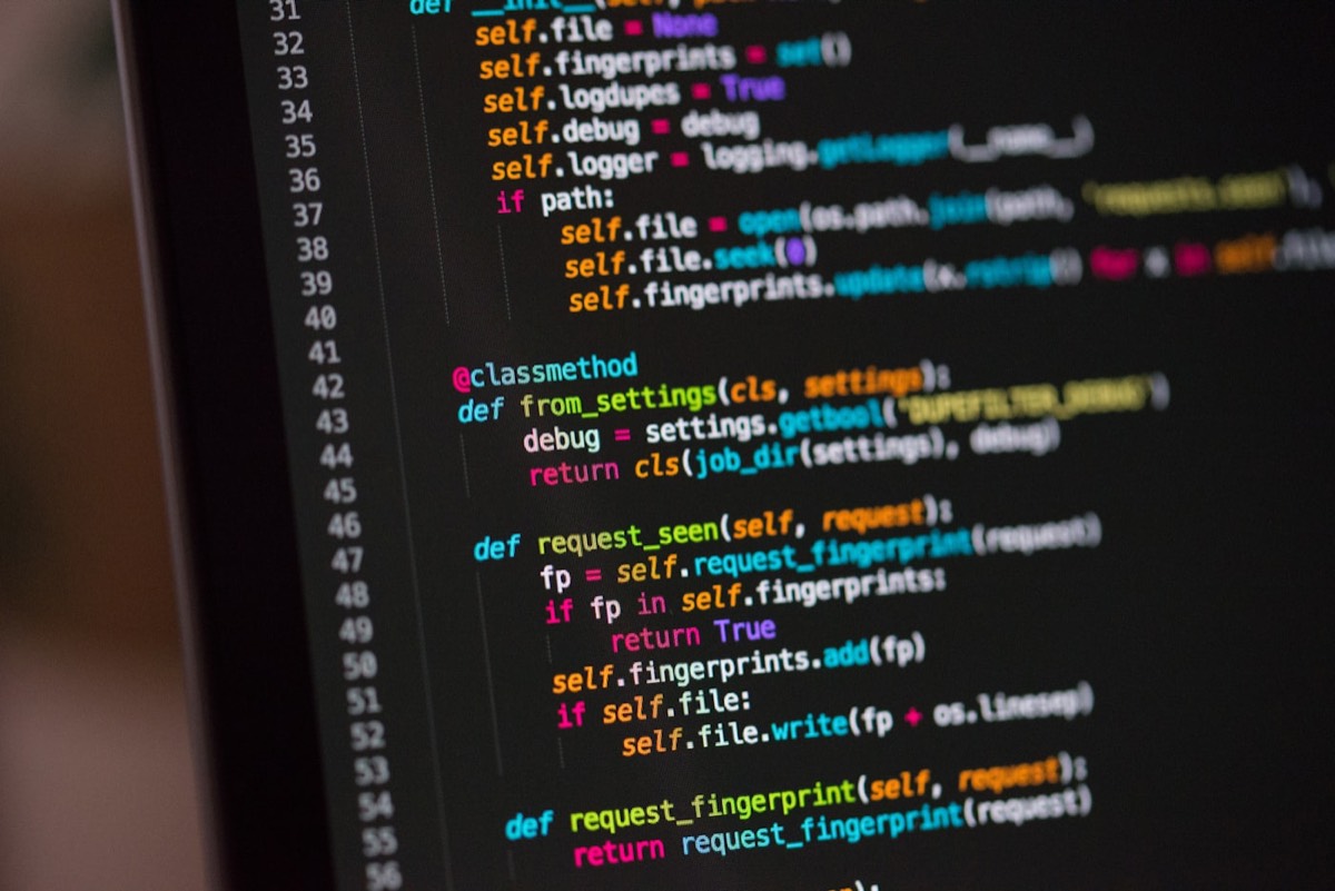 Developer working on code on a laptop screen