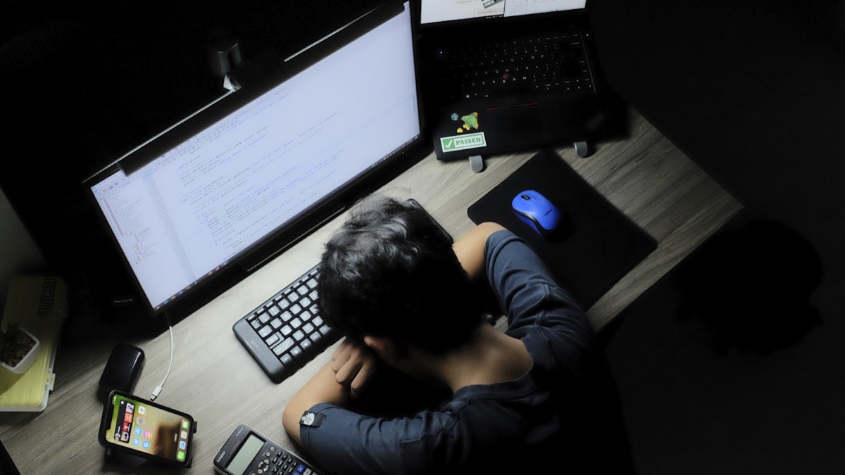 Person looking frustrated while checking a website on a laptop